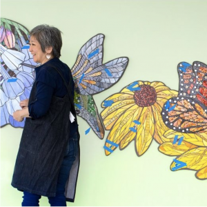 Artist Aya Kinoshita of Lancaster puts the finishing touches on her stained glass and ceramic tile artwork at Penn State Health Hampden Medical Center.